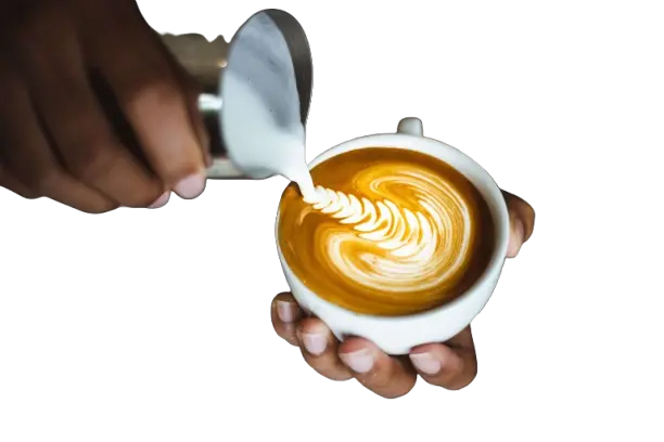 Barista pouring milk into latte with art